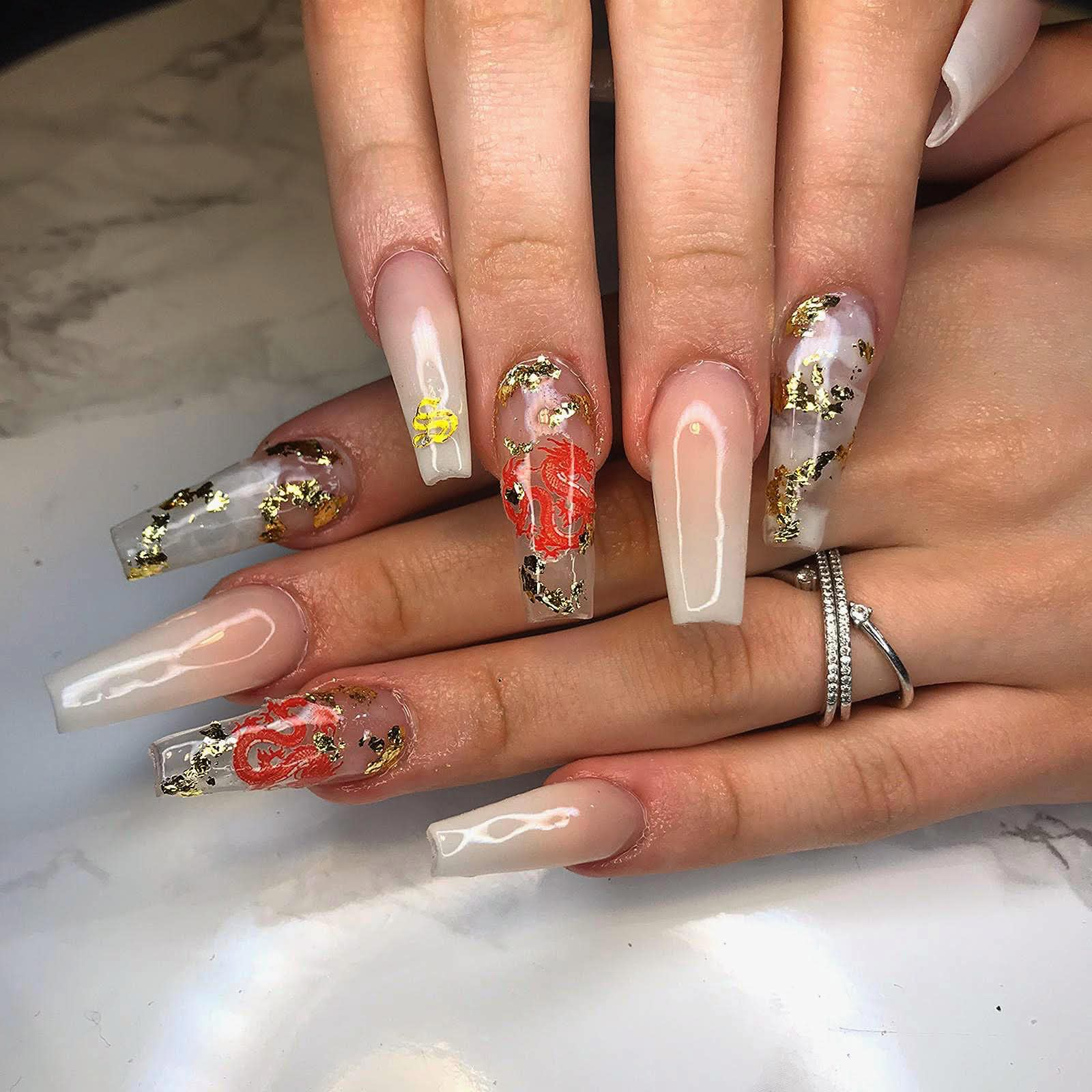 The same hand pose transformed with long custom dragon and gold nail art