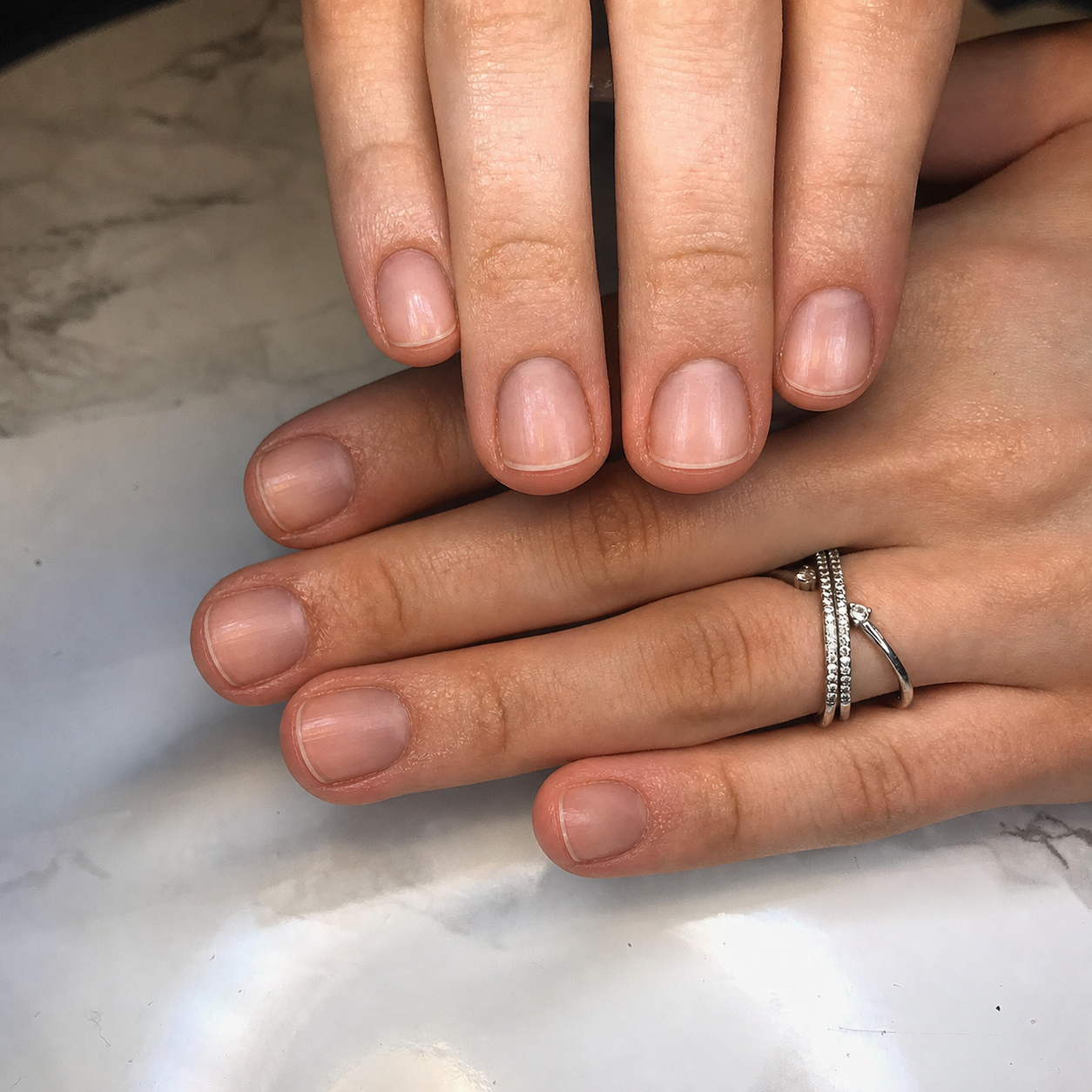 Two real hands with short healthy natural nails